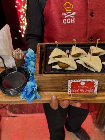 Our Falafel Pita Pockets offer creamy goodness packed in every bite. Served on a wooden grill platter, they are a delicious and healthy option for your guests.