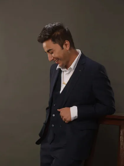 A candid moment during a photoshoot in a three-piece suit. I believe in dressing well and bringing a professional and polished look to your formal events.