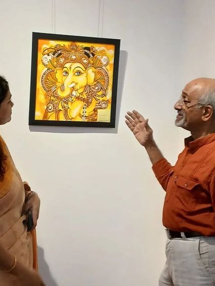 Explaining the details of a Kerala mural Ganesha to a senior artist and visitor.