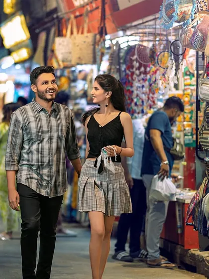 A casual stroll through the bustling Rishikesh market. This shot captures the couple in a real-life setting, blending their story with the vibrant culture of the city.