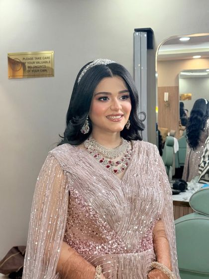 This client looks like a princess. The soft makeup and elegant hair accessory are perfect for her glamorous gown.