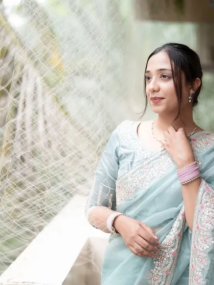 A moment of quiet elegance for the bride on her reception day. Dressed in a beautiful saree, she takes a moment to herself on the balcony, creating a serene portrait.