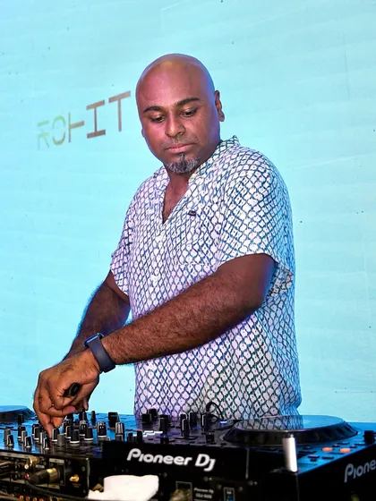 Focused behind my trusted Pioneer DJ console. For me, it's all about precision mixing and reading the crowd to play the right track at the right time, ensuring the dance floor never stops.