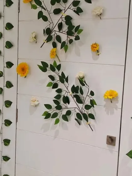 Simple and elegant floral decor on an office door, using green vines and scattered flowers. This small detail contributes to a cohesive and decorated feel throughout the entire space.