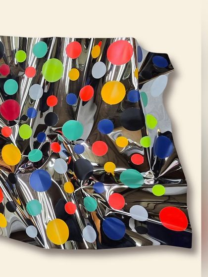 This detail shot highlights the three-dimensional quality of the sculpture, where the steel appears to be in motion.