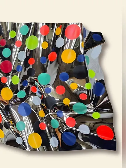 This detail shot highlights the three-dimensional quality of the sculpture, where the steel appears to be in motion.