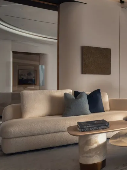 A living space that breathes quiet luxury, where the material palette is a study in restraint. Limewash-painted walls and fluted veneers introduce subtle depth, while brass accents at curved junctions tie the architecture and interiors together with understated warmth.