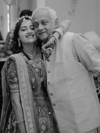 A bride sharing a warm, happy hug with her father during the Mehendi ceremony. These candid shots are filled with the genuine warmth and joy that define family celebrations.