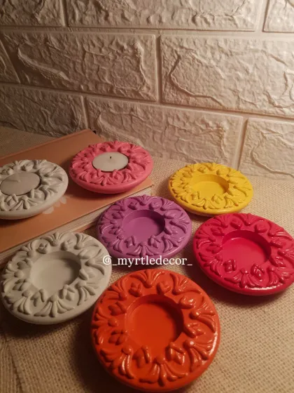 Our colorful diya holders styled on a table. This image shows how they can be used both with and without candles as decorative pieces.