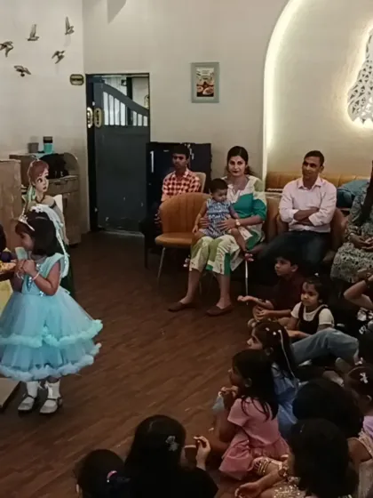 A young guest gets to be part of the magic show, creating a memorable and interactive experience.