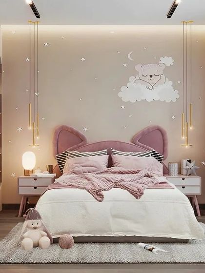 This charming bedroom features a custom pink bed with cute cat-ear details on the headboard. We added star-themed wall decals and elegant pendant lights to create a dreamy and peaceful environment for a child.