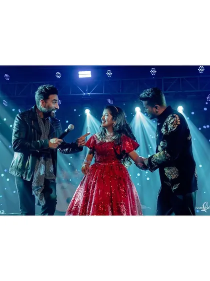 Another angle of Deeksha's surprise performance with Shekhar. The stage lights and the interaction between the artists create a vibrant and energetic concert-like photo.
