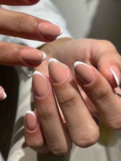 A classic French manicure on almond-shaped nails. The elegant shape and timeless design create a look of effortless sophistication.