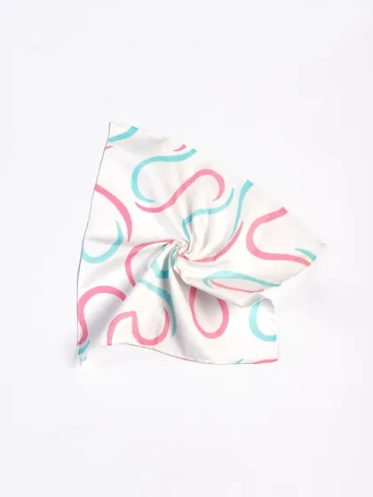 A minimalist shot focusing on the abstract pattern and texture of a fabric accessory. The simple twist and clean white background turn the product into a piece of abstract art.