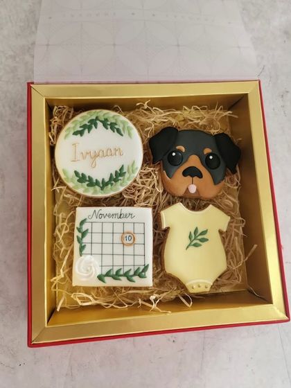 A closer look at the baby announcement cookie set. The details, like the little calendar and the dog's sweet face, make it so personal.