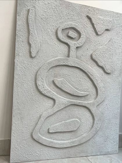 The full view of the abstract textured piece before installation. The asymmetrical, primitive-inspired design is both modern and timeless.