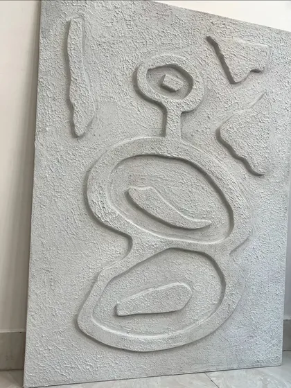 The full view of the abstract textured piece before installation. The asymmetrical, primitive-inspired design is both modern and timeless.