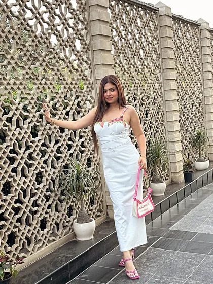 A beautiful white midi dress with floral embroidered straps. This is an elegant and timeless look for any special occasion.