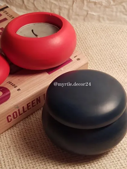 The mini jar with its lid on, shown in a deep navy blue. This smooth, pebble-like jar is a wonderfully tactile object to have on your desk or bedside table.