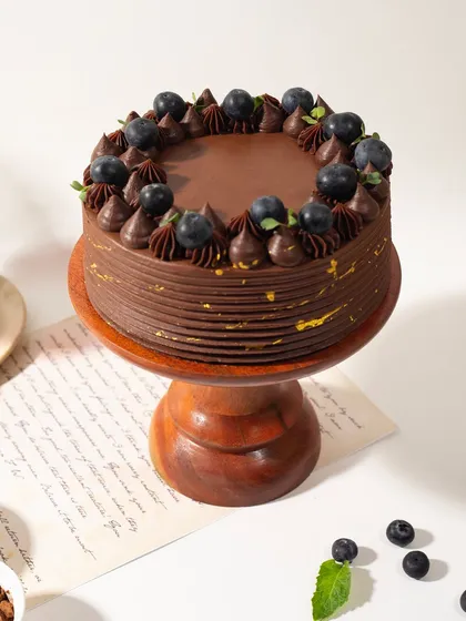 Decadent chocolate meets tangy berries. This cake is all about that perfect flavor combination, with a rich frosting and a touch of gold leaf for elegance.