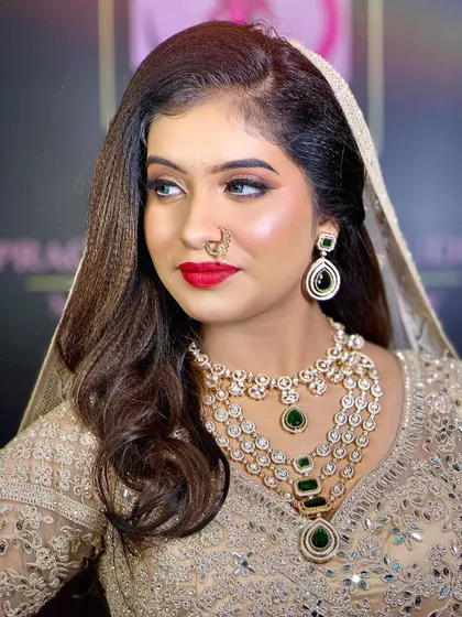 A side profile of this elegant party look, showing the flawless base and the perfectly defined eye makeup.