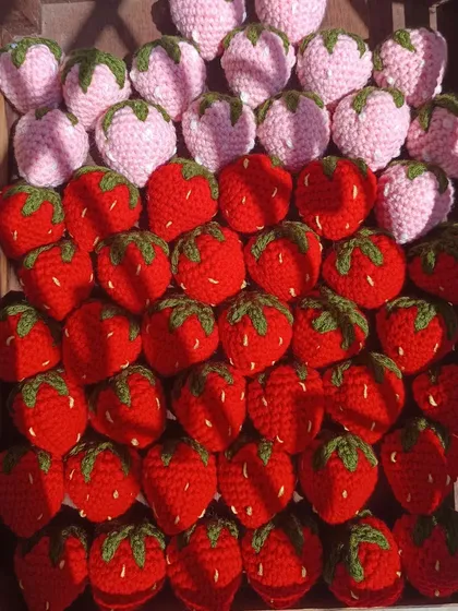 A crate of red and pink strawberries, perfect for keychains or decor.