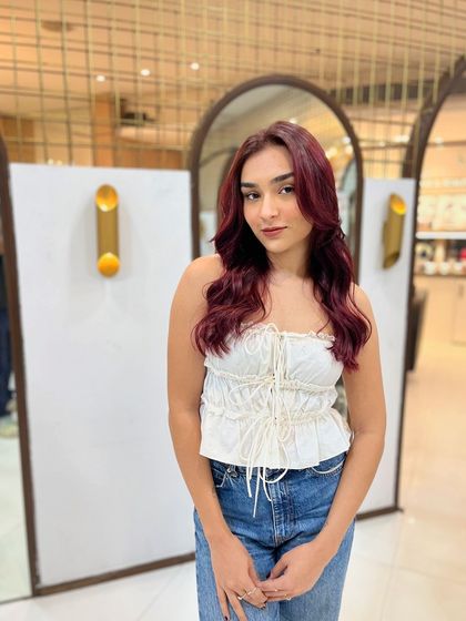 A beautiful result of our red wine colour service. The shade is deep and rich, and the soft waves showcase the colour's dimension.