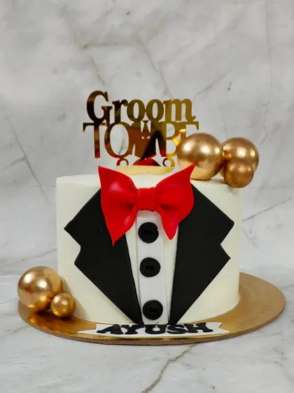 Celebrating the groom-to-be with a cake that's as sharp as his suit. This tuxedo-themed cake is a fun and stylish way to kick off the wedding festivities for the bachelor party or engagement.