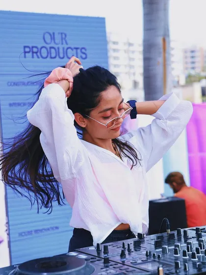 Tying up my hair, getting ready to drop the next beat at a daytime event. The work behind the fun is always ongoing.