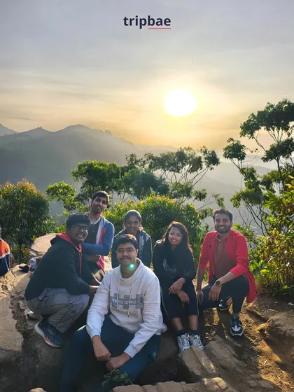 A stunning sunrise view from a viewpoint in Kodaikanal, with our travelers taking in the magical moment.