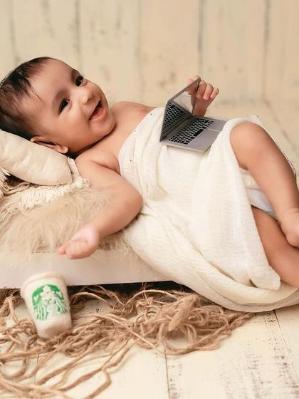 Chilling out after a hard day's work. This pose is both adorable and humorous, making for a unique newborn portrait.