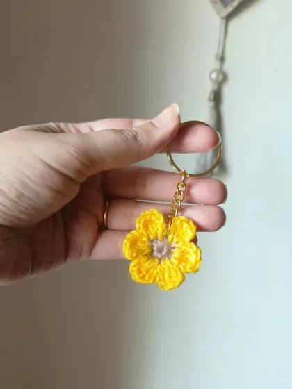 This yellow floral keychain has a soft brown center, just like a little daisy. It's a cheerful addition to any set of keys.
