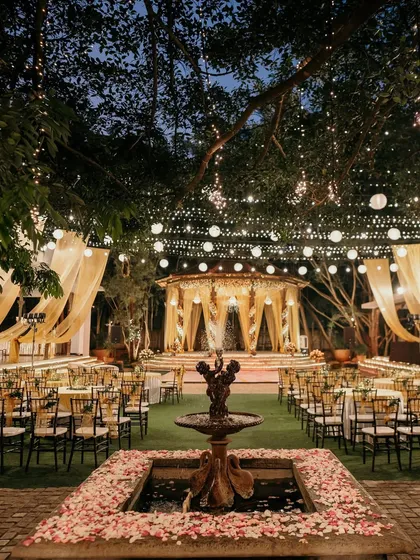 An enchanting Sangeet night under a canopy of fairy lights and flowing drapes. We focus on creating an immersive atmosphere with strategic lighting and elegant seating arrangements, ensuring a magical evening of music and celebration.