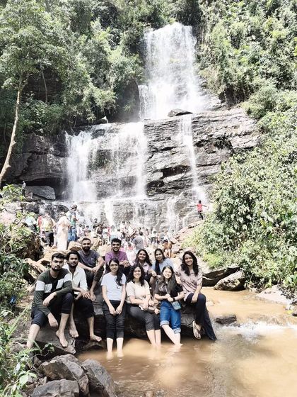A group photo on the rocks beside Hebbe falls, a popular spot on our Chikmagalur tour.
