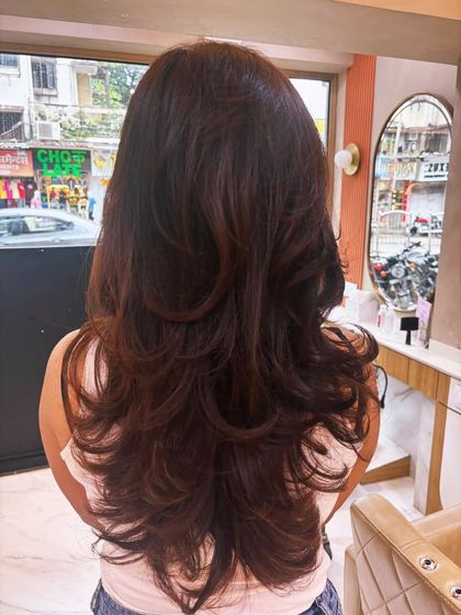 A beautiful long-layered haircut. The layers add volume and movement, creating a soft and feminine style.