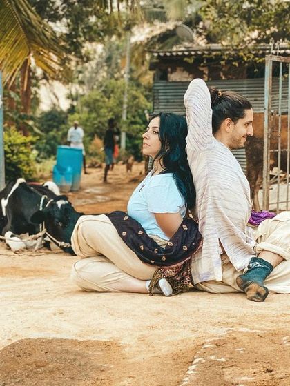 Students practice Gomukhasana (Cow Face Pose) near the goshala (cow shelter). This is a playful tribute to the sacred cows of India, connecting our asana practice to the culture around us.