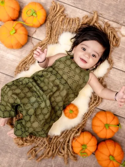The cutest little pumpkin in our patch. We love creating seasonal sets like this autumn-themed pumpkin patch shoot, perfect for capturing your baby against a warm and festive backdrop.