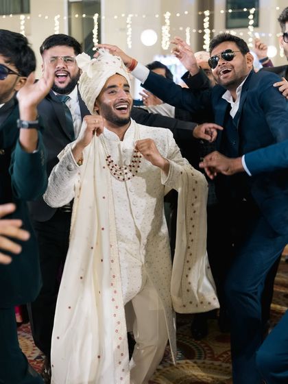 The groom having the time of his life dancing with his friends.