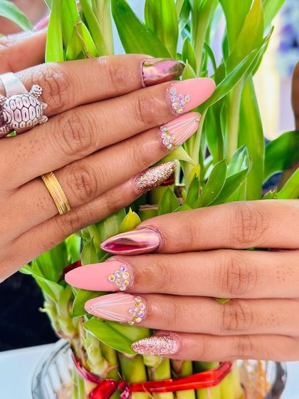 This design combines multiple textures: a matte pink base, rose gold chrome, rose gold glitter, and intricate rhinestone work. It's a truly glamorous and eye-catching set.