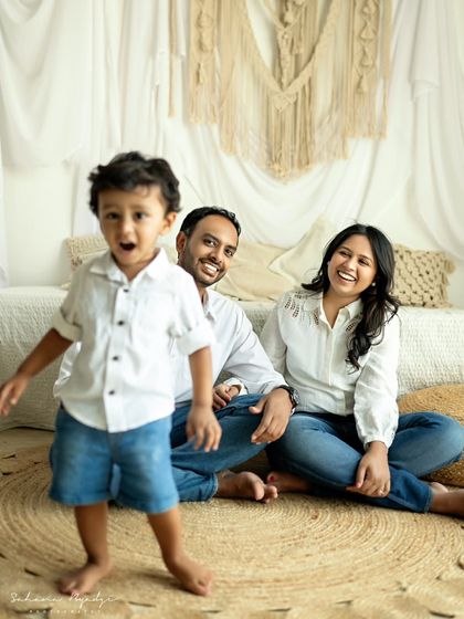 A duplicate of image 56, showing an energetic little boy running towards the camera while his parents laugh in the background. A perfect candid moment.