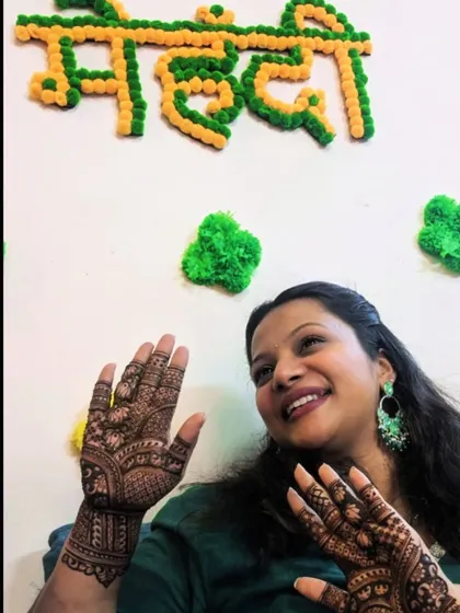 Posing with her finished mehendi in front of a festive backdrop. It's always a pleasure to see my clients so happy with my work.