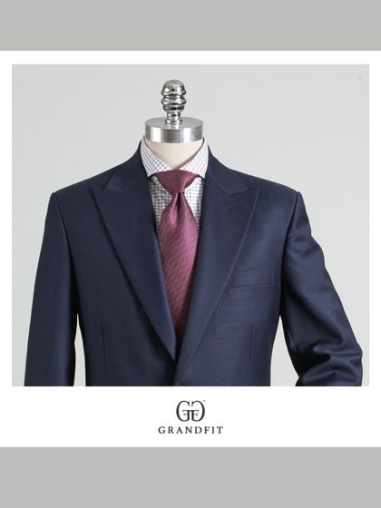 A close-up view of the navy suit, paired with a patterned shirt and a rich burgundy tie, showcasing how our suits serve as a perfect canvas for personal styling.