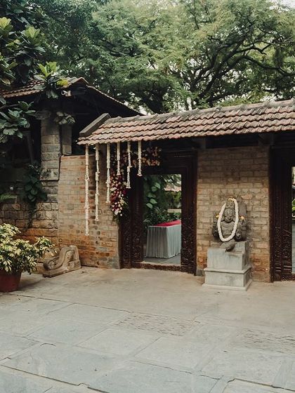 The entrance to the venue decorated with simple floral hangings and a welcome sign.