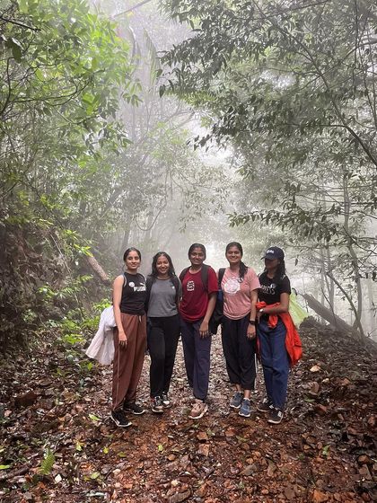Friends posing together on a misty trail during the Kurinjal trek.