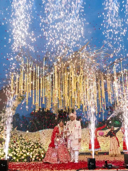 A magical varmala moment under a canopy of flowers, with cold pyro fireworks adding to the spectacle. We design these key moments to be visually stunning from every angle.
