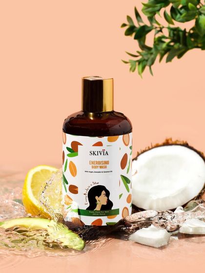This dynamic shot captures a body wash in a splash of water, surrounded by its key ingredients. The action and fresh elements like coconut, lemon, and avocado make the product feel energizing and natural.
