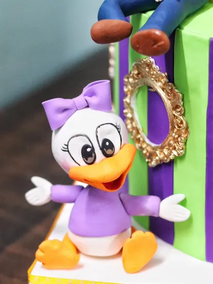 A close-up of the hand-sculpted Daisy Duck figurine.