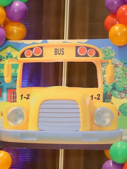 A fun photo prop of the iconic yellow Cocomelon school bus, perfect for kids to pose with.