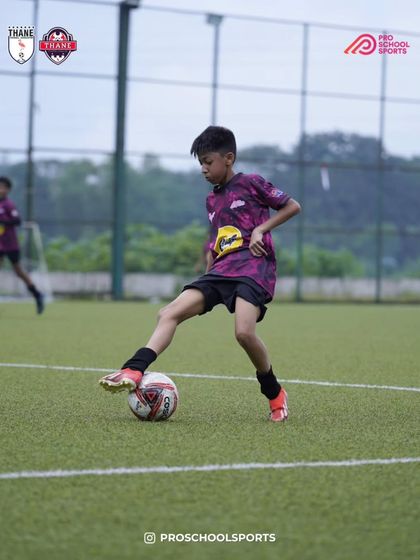 A young player shows great technique while controlling the ball.