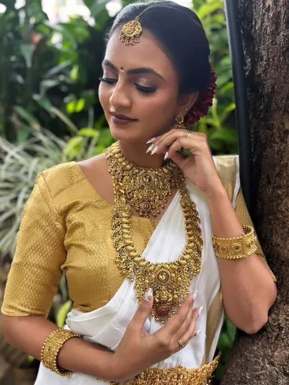 I have a special place in my heart for the elegance of South Indian bridal looks. This look features classic temple jewellery, a beautiful hair bun with fresh flowers, and makeup that highlights the bride's grace.